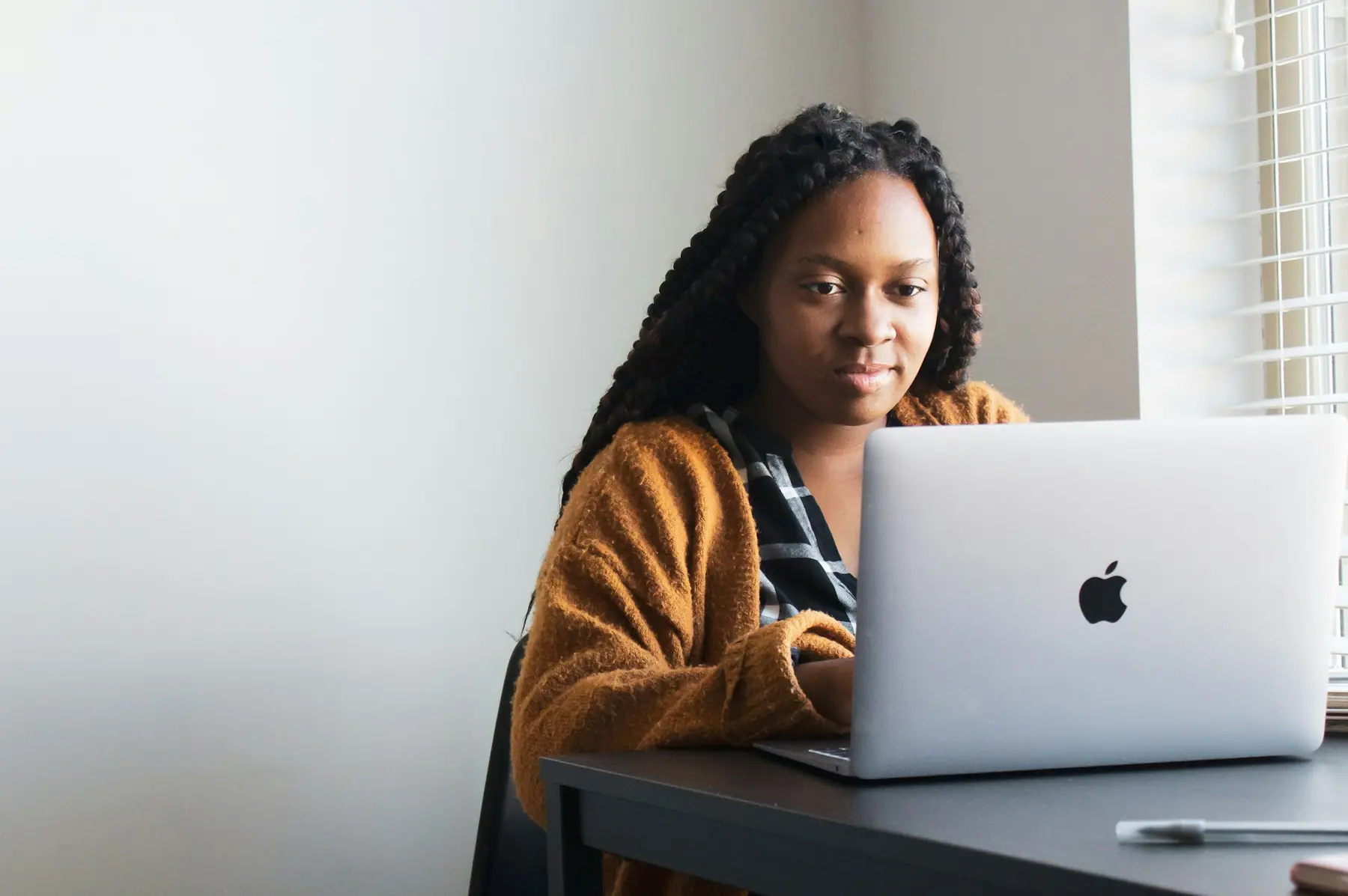 Business owner working comfortably at her laptop, confident her website is looked after