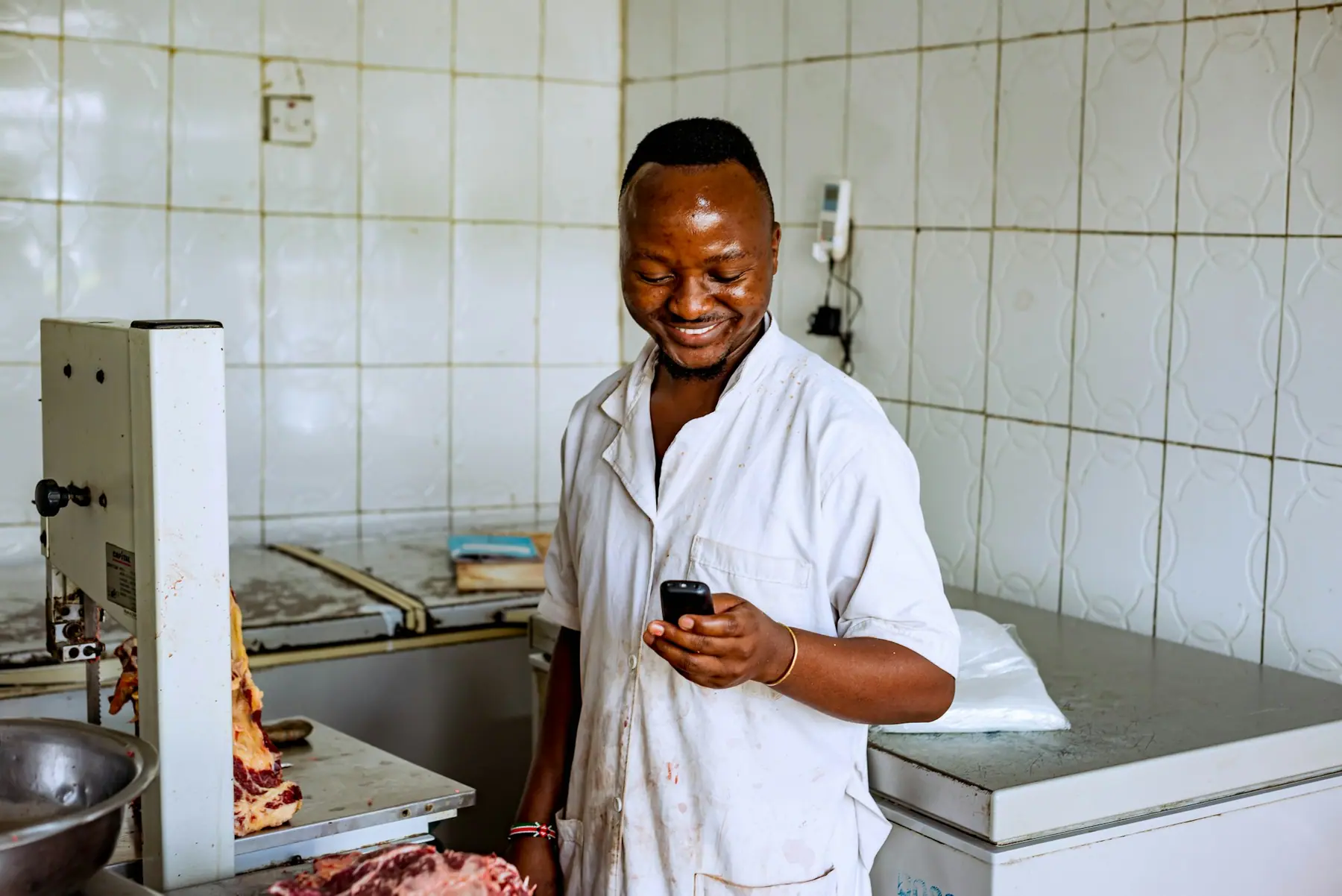 Food business owner checking an order on his phone