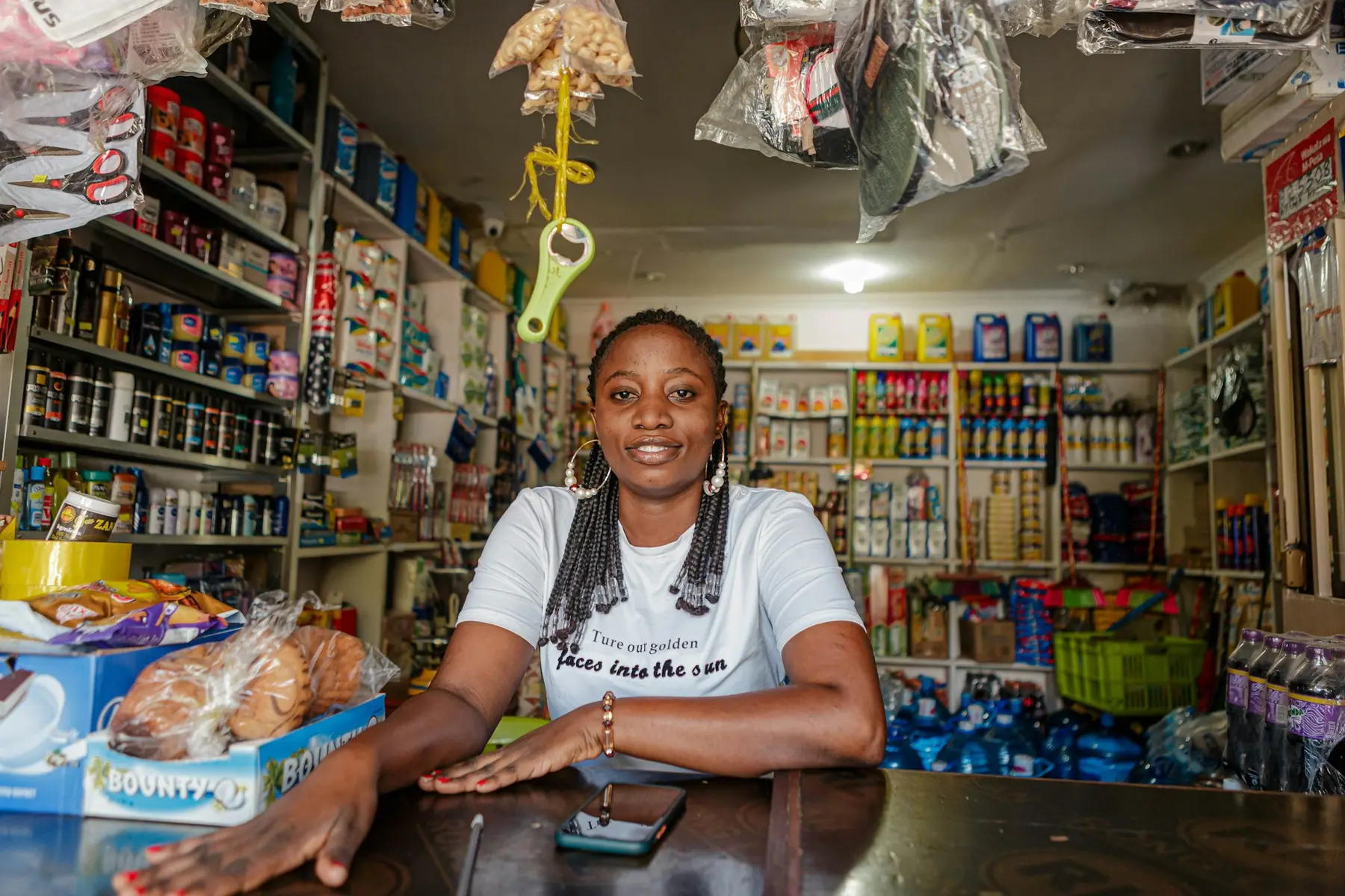 Owner of an independent shop at her counter, ready to serve customers